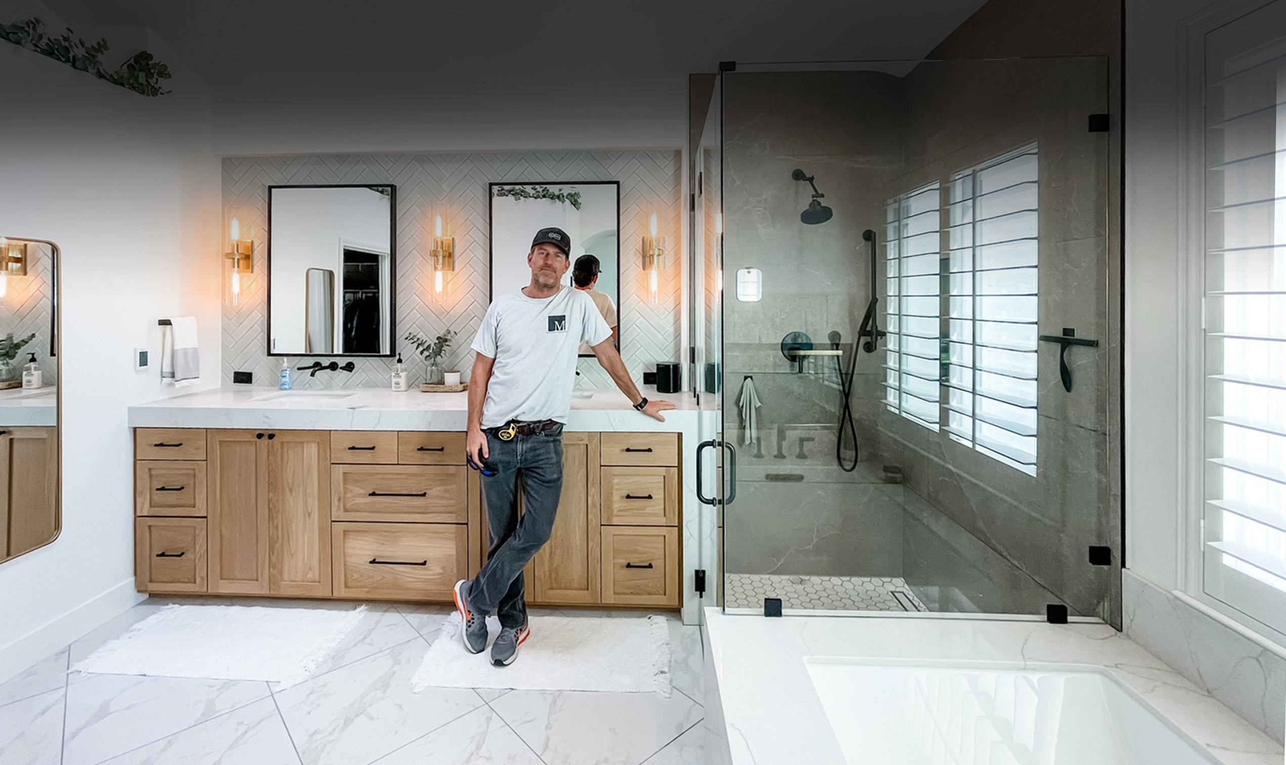 Tyler standing in a beautifully finished bathroom