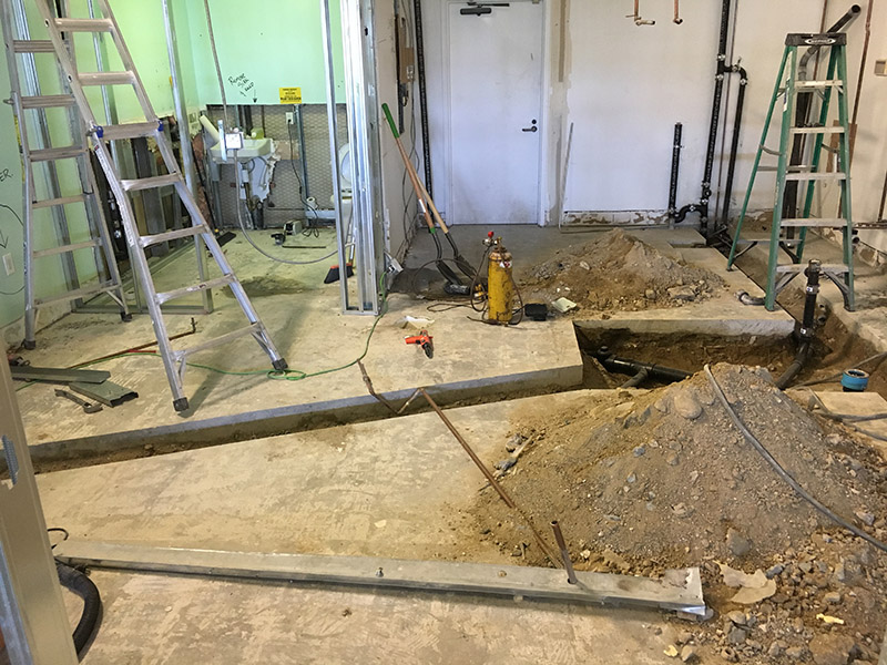 Commercial interior under construction showing plumbing cut-in