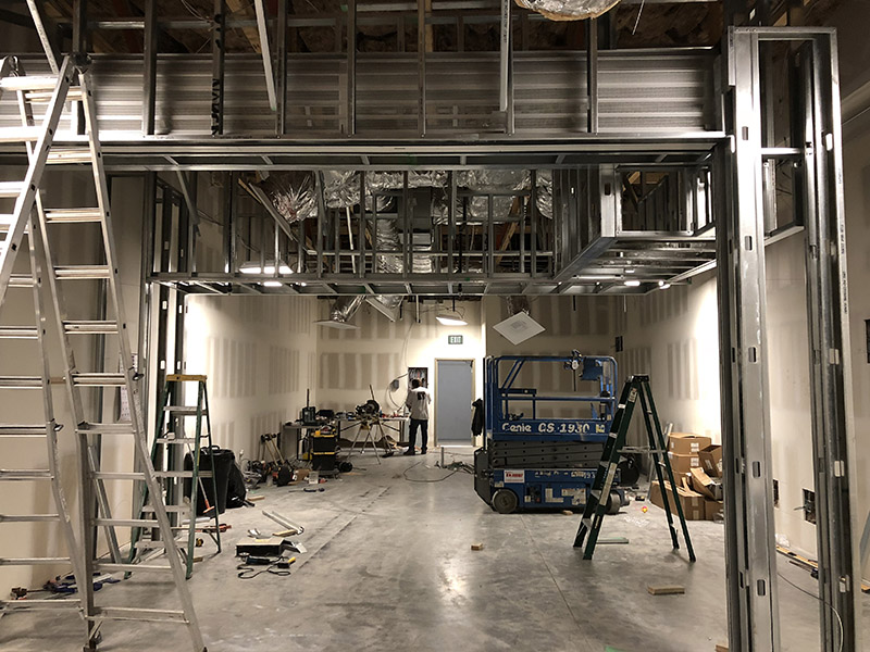 Photo of partitional walls and HVAC being installed in commercial space.